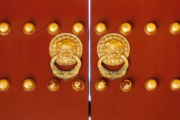 istock Antique red doors with weathered gold handles 183329639