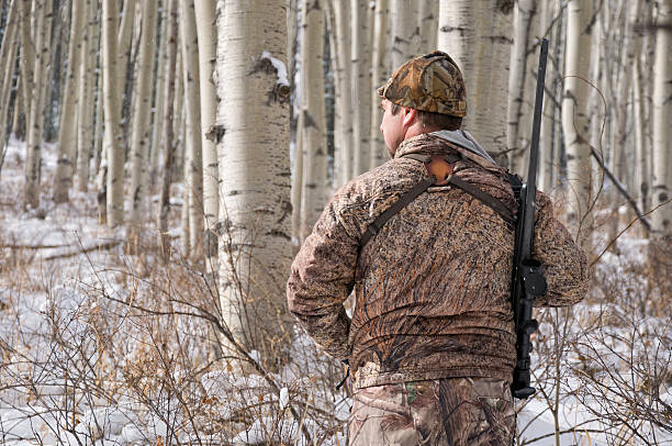 istock Rifle Hunter in Winter Wearing Camouflage 183330089