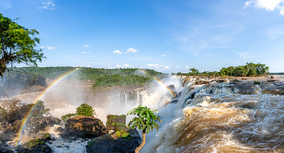 Rainbow and the breathtaking mighty Iguazu Falls in Iguazu National Park on the Boarder of Argentina and Brazil, South America