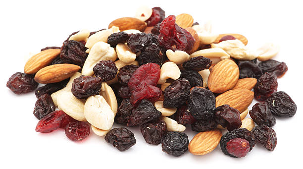 istock Mixed nuts and dry fruits pile isolated on white 183330220