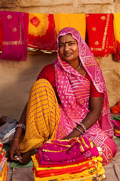 istock Indian woman selling colorful fabrics 183331129