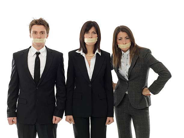 istock business team with mouth closed 183331233