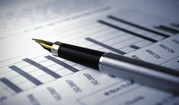 Photo of Financial report graph with pen