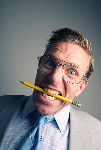 istock Stressed Out Businessman Chews on Pencil 183331936