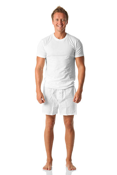 einsamer mann stehen in weißem hemd und boxershorts - underwear men shorts isolated stock-fotos und bilder