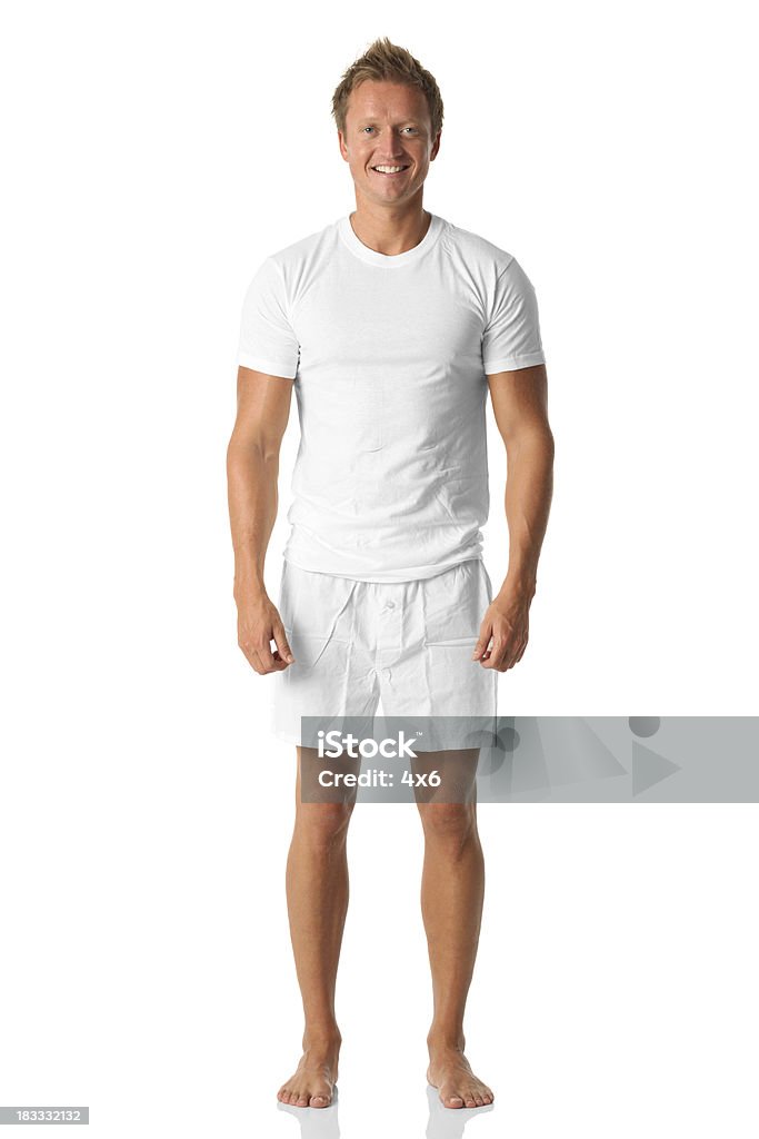 Isolated man standing in white shirt and boxers Isolated man standing in white shirt and boxershttp://www.twodozendesign.info/i/1.png Men Stock Photo