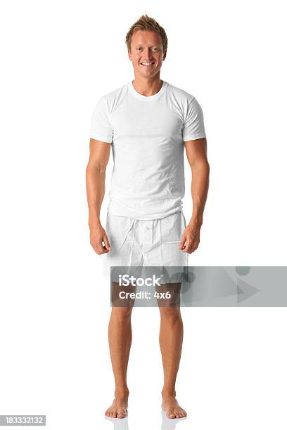 Isolated Man Standing In White Shirt And Boxers Stock Photo - Download Image Now - Men, Barefoot, T-Shirt