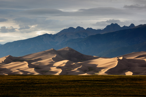 Setting sun illuminates the sand dunes of the Great Sand Dunes National Park in southern Colorado.