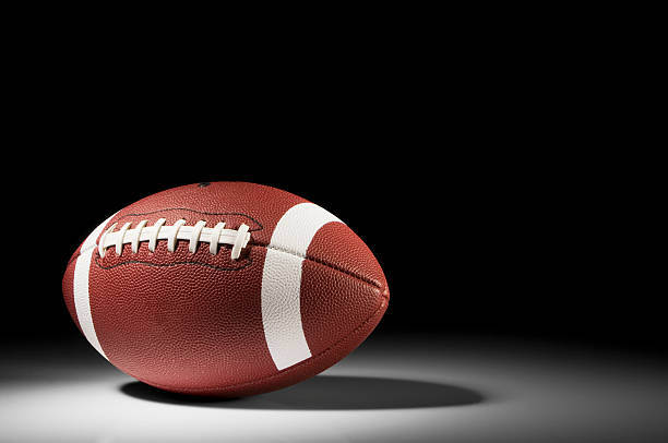 istock American football in spotlight on white background 183332480