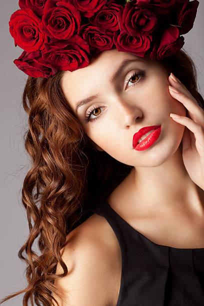 istock Beautiful woman with red flowers 183332700