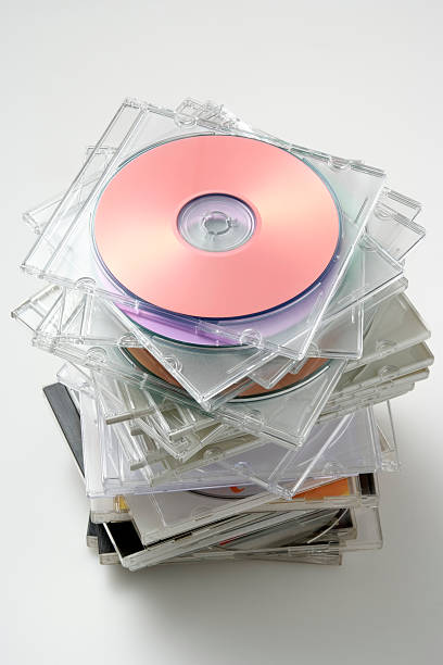 Isolated shot of stacked disk case on white background Stacked CD/DVD case isolated on white background with shadow. clear cd case stock pictures, royalty-free photos & images