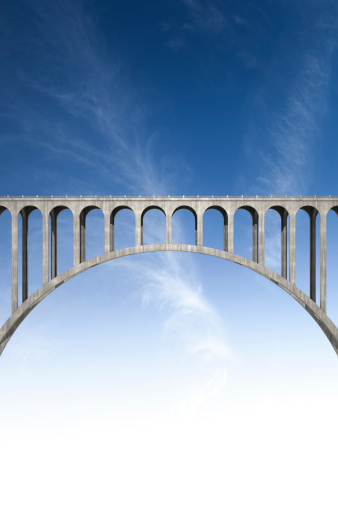 Side view of a concrete bridge with blue sky background. This image contains copy space for your image or message.Could be useful in a bridge metaphor composition.This is a detailed 3d rendering.