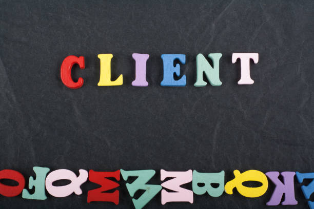 istock CLIENT word on black board background composed from colorful abc alphabet block wooden letters, copy space for ad text. Learning english concept. 1833339578
