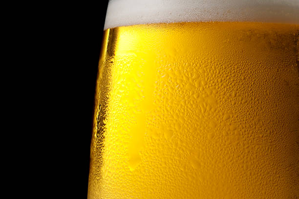Isolated shot of dewy cold beer glass against black background