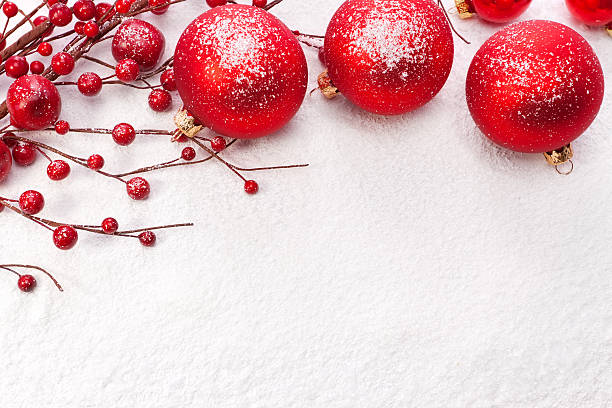 Red Christmas balls on the snow. Christmas decoration.