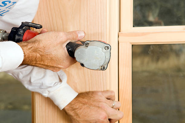 istock Worker Fastening Window Trim with Pneumatic Nail Gun 183334366