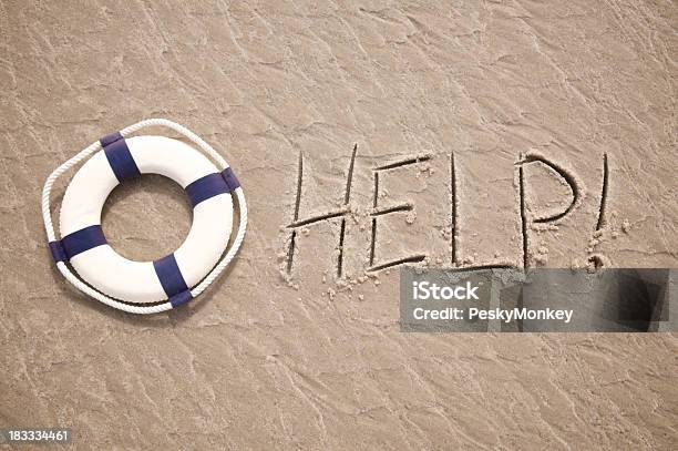 Help Message Written In Sand With Lifesaver Stock Photo - Download Image Now - SOS - Single Word, A Helping Hand, Assistance