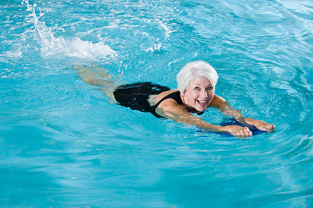 istock Active senior woman exercising in swimming pool 183334536