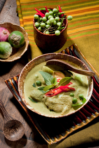 Thai Green Curry With Chicken & Fresh Ingredients As Garnishing.