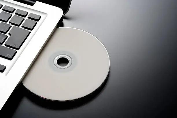 Photo of Inserting a blank CD into a laptop with copy space