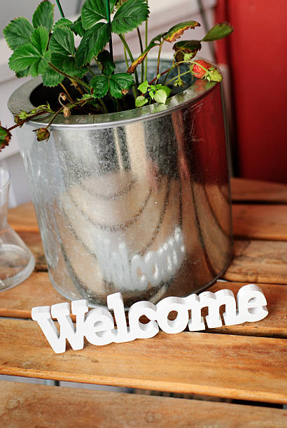Welcome Sign and Strawberry Plant on Table
