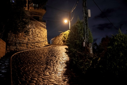 wet cobblestone street in the Lebanon village Broummana at night