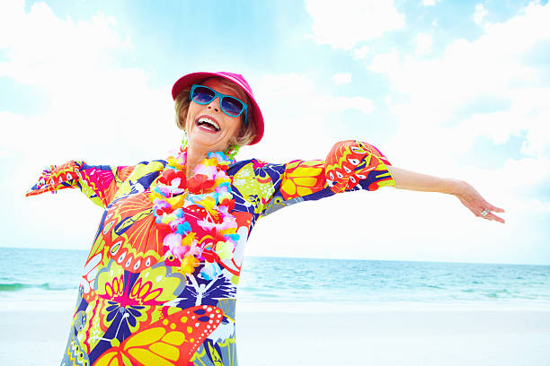 Freedom! Retired woman outdoors with arms outstretched brightly lit stock pictures, royalty-free photos & images
