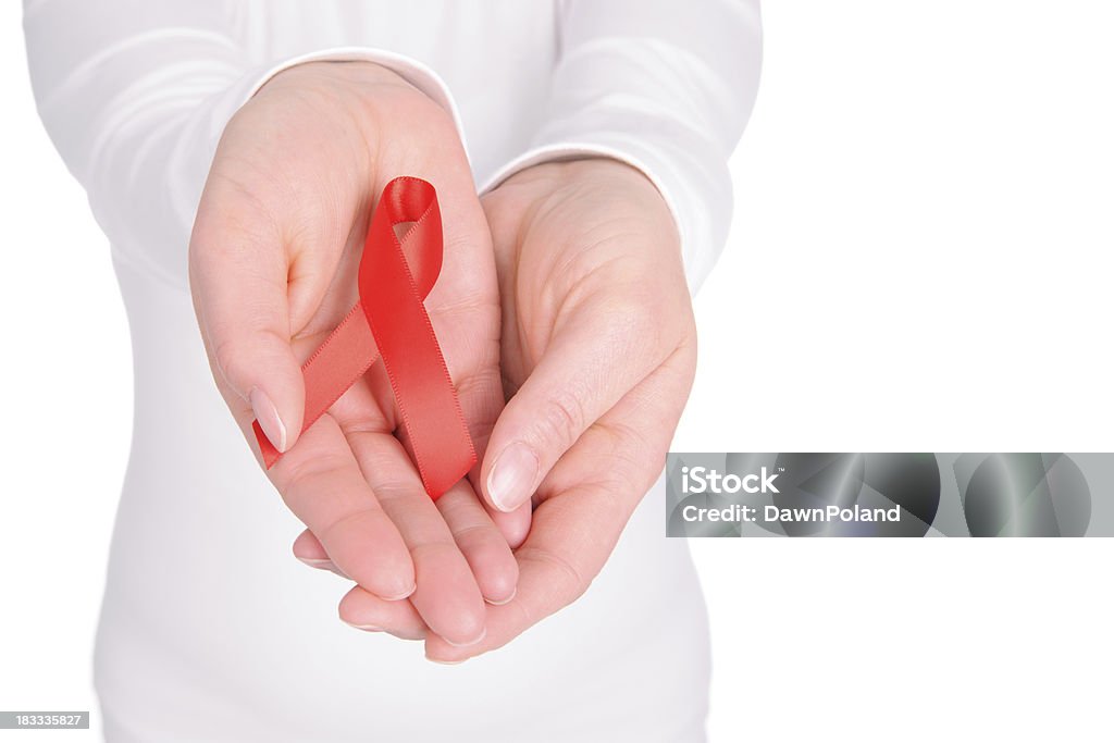 Aids & Heart Disease Awareness Hands holdinding a Aids Awareness Ribbon on a white background with copy space for your special text. AIDS Stock Photo