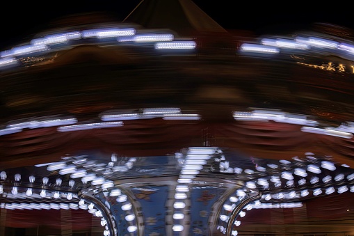 close up of a spinning carousel in motion at night