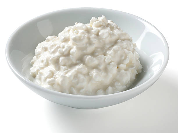 Half Cup serving of Cottage Cheese, white background Half cup serving of low fat cottage cheese in a bowl on a white background with natural shadow.Shot with a Nikon D3X.My Food Lightboxes cottage cheese photos stock pictures, royalty-free photos & images