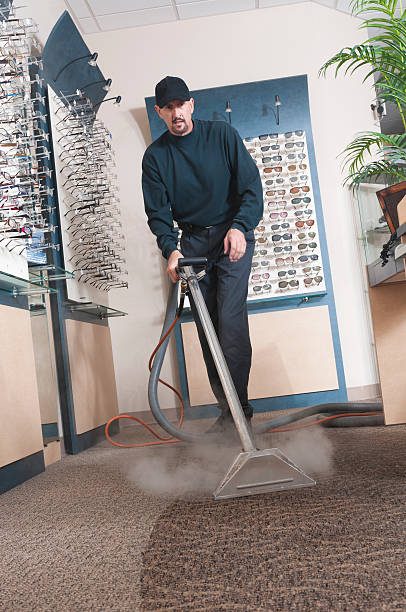 A professional carpet cleaner at work stock photo