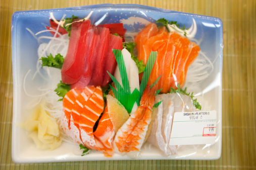 Packaged raw fish wrapped in cellophane.