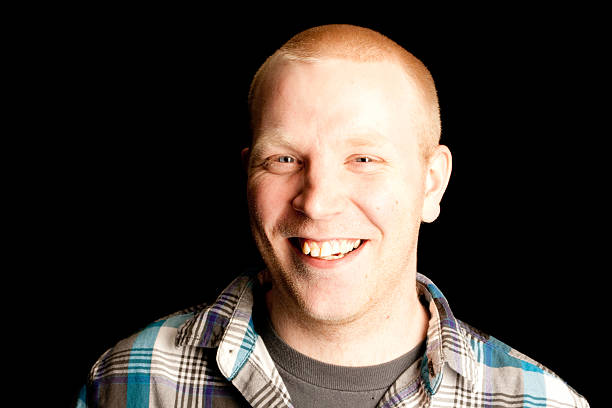 istock Man with buzzed hair smiling at the camera 183336859