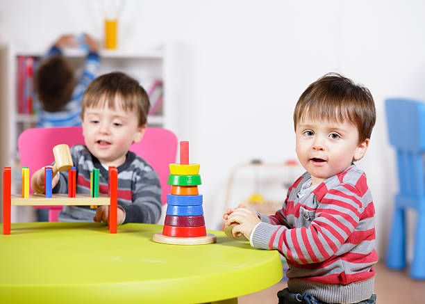 istock Identical Twin Boys Playing With Multi-coloured Toys 183336977