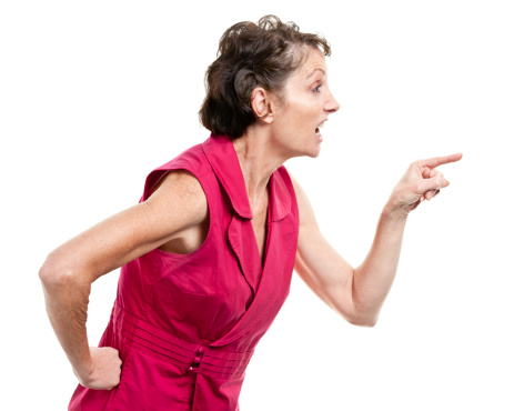 Side view of a furious mature woman arguing with someone.
