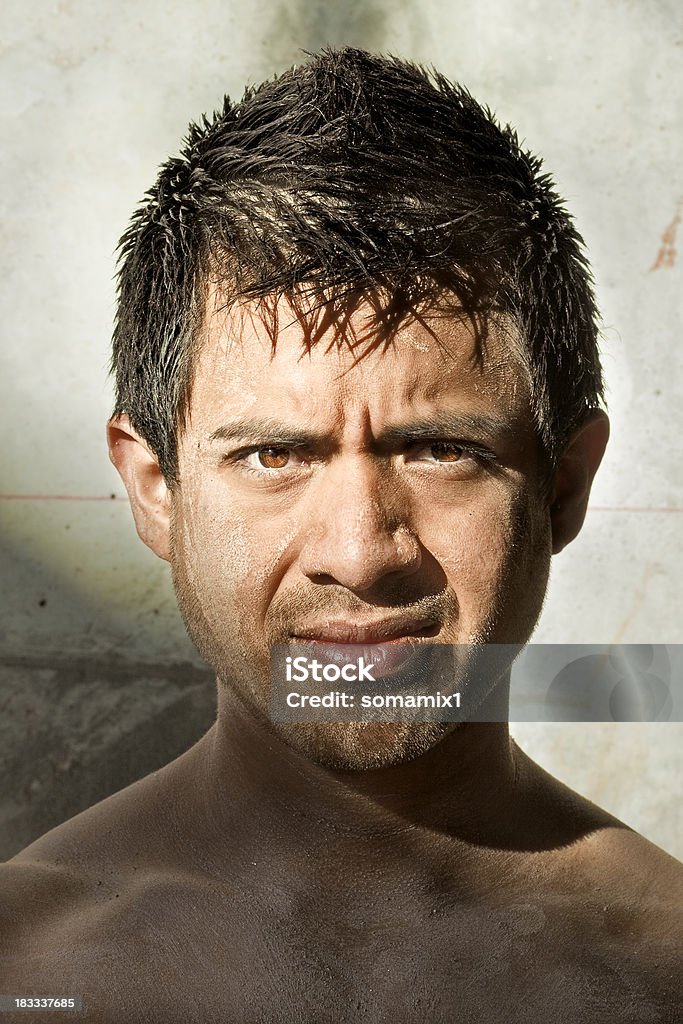 Hispanic Male Portrait Portrait of Hispanic Male covered in dirt emerging from the shadows. 20-29 Years Stock Photo