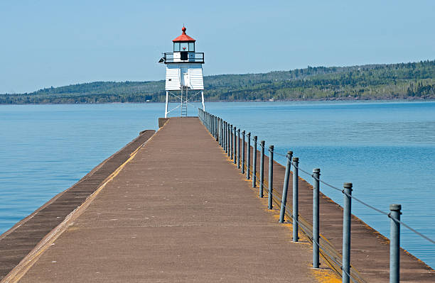istock Lighthouse at entrance to harbor 183338947