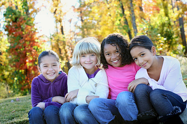 Four girls in the park Four girls in the park only girls stock pictures, royalty-free photos & images