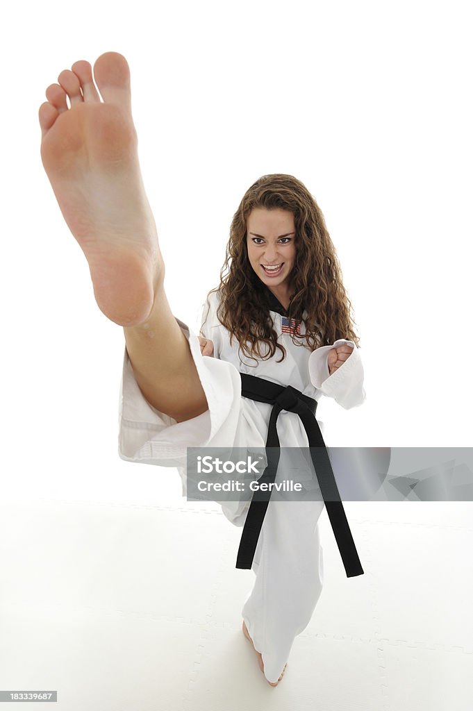 Striking high Martial artist executing a high front kick. Combat Sport Stock Photo