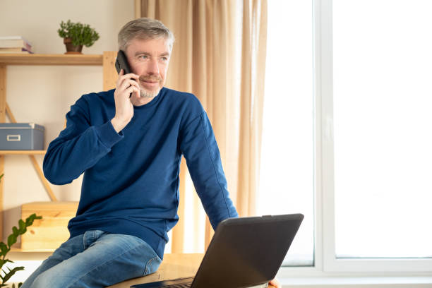 istock 50 year old male freelancer working in home office 1833401640
