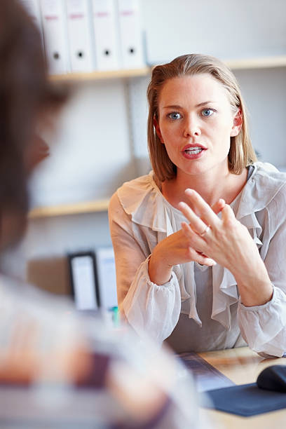 istock Attractive executive having serious conversation with colleague 183340320