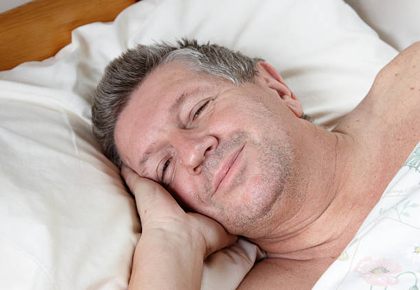 istock Mature man half asleep in bed 183340391
