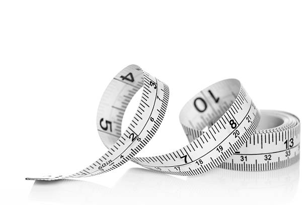 Tape measure on white background White tape measure on white background with reflection centimeter photos stock pictures, royalty-free photos & images