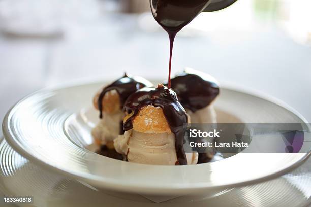 Closeup Picture Of Profiteroles Bathing In Chocolate Stock Photo - Download Image Now