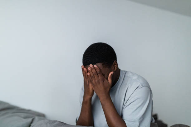 istock Depressed young black men sitting in bed 1833410397