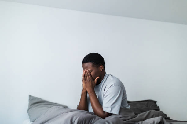 istock Depressed young black men sitting in bed 1833412207