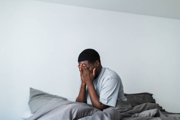 istock Depressed young black men sitting in bed 1833413050