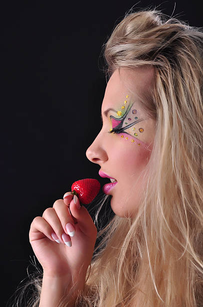 istock woman eating strawberry 183341720