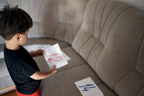 istock A boy with autism puts numbers in order. 1833417988