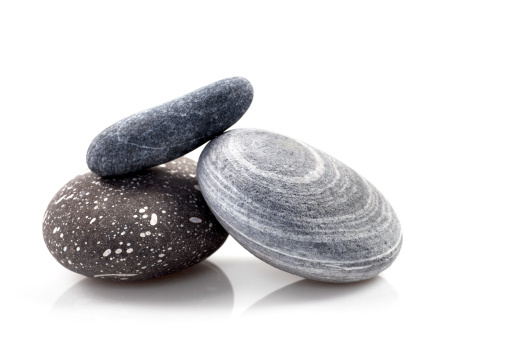 Three zen stones on white background